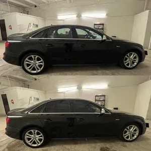 Black sedan shown in side view twice, parked in a garage-like space under bright lights.