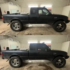 Black lifted pickup truck shown in side view, displayed in two stacked photos inside a garage.