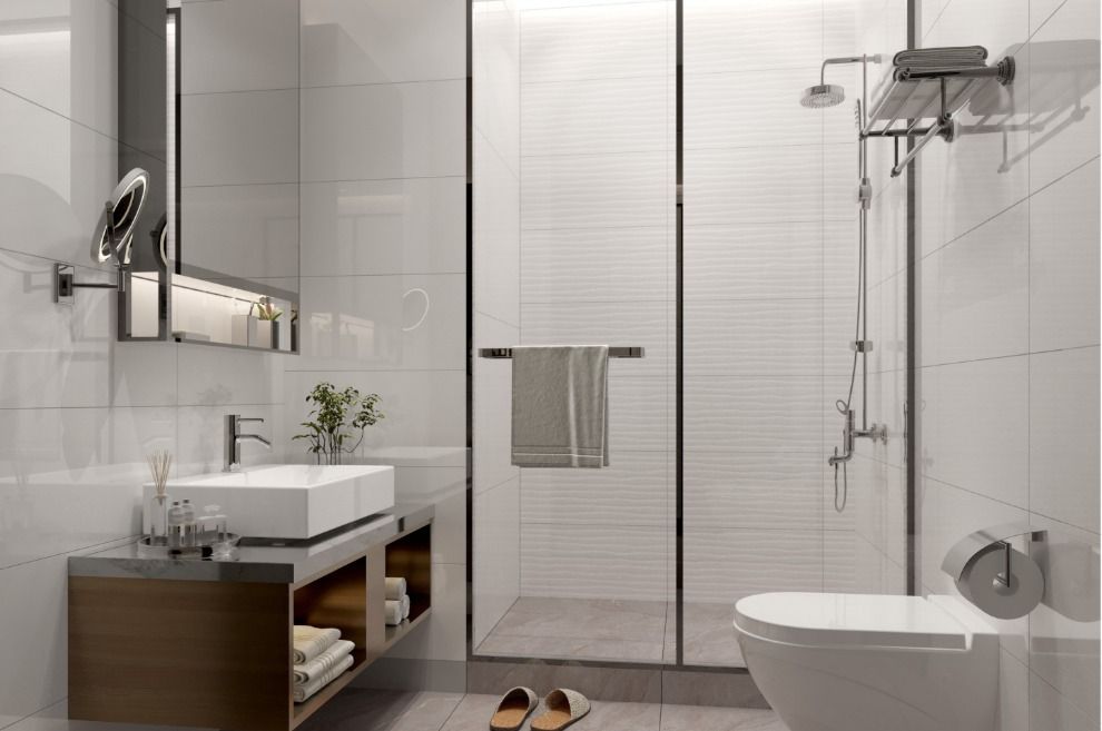 Modern bathroom with white tiles, glass shower, floating vanity, and toilet.
