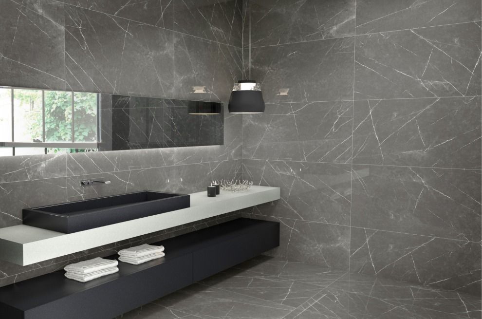 Modern bathroom with dark gray marble-look walls, rectangular sink, and floating vanity.
