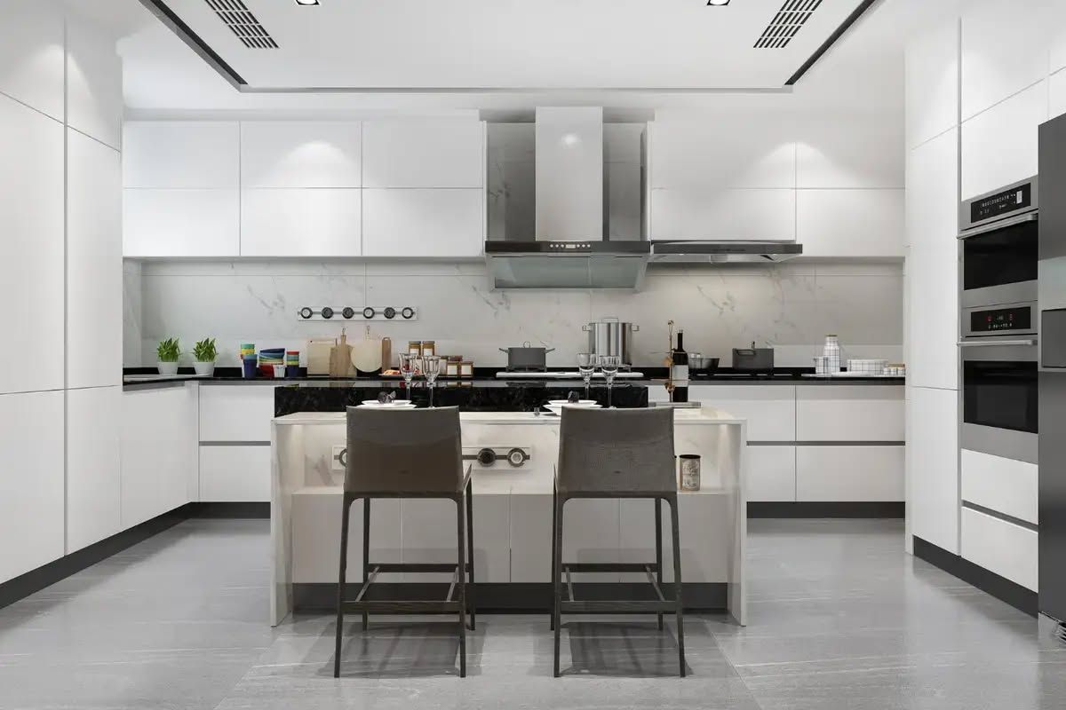 Modern white kitchen with island, stainless steel appliances, and two bar stools.