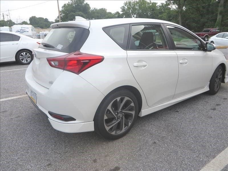 White Scion iM hatchback parked in a parking lot.