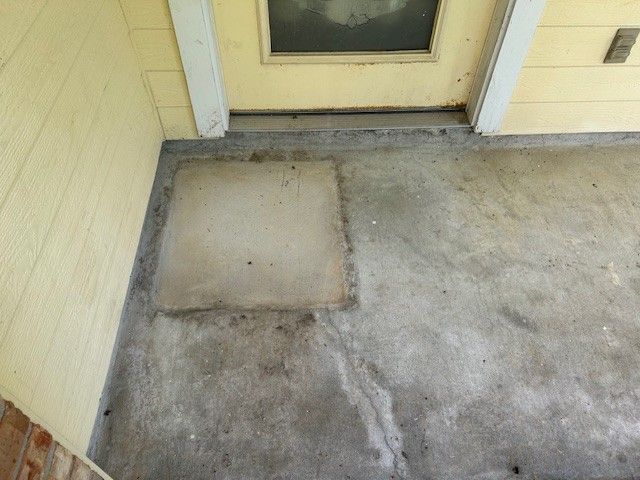Concrete porch with a square patch