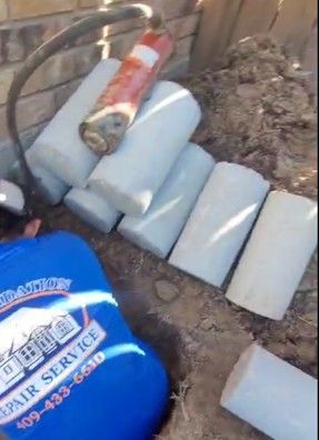 Cylindrical concrete piers near a house