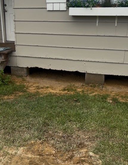 A house with visible concrete blocks under the siding