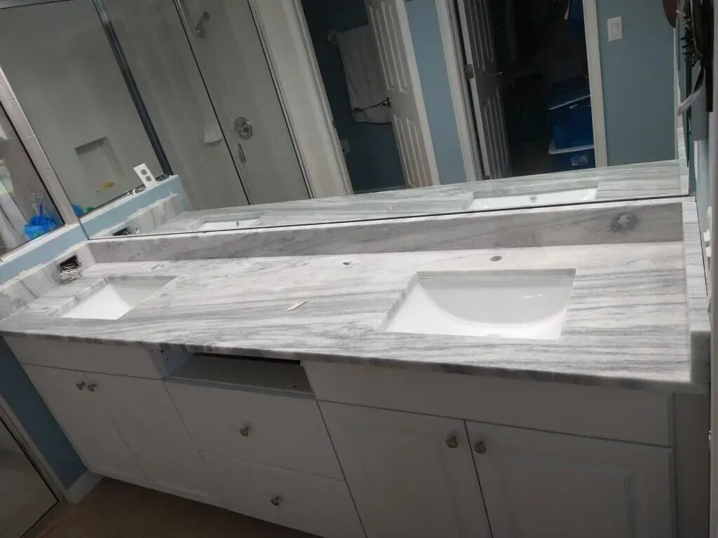Bathroom vanity with double sinks, gray cabinets, and mirrors in a modern interior