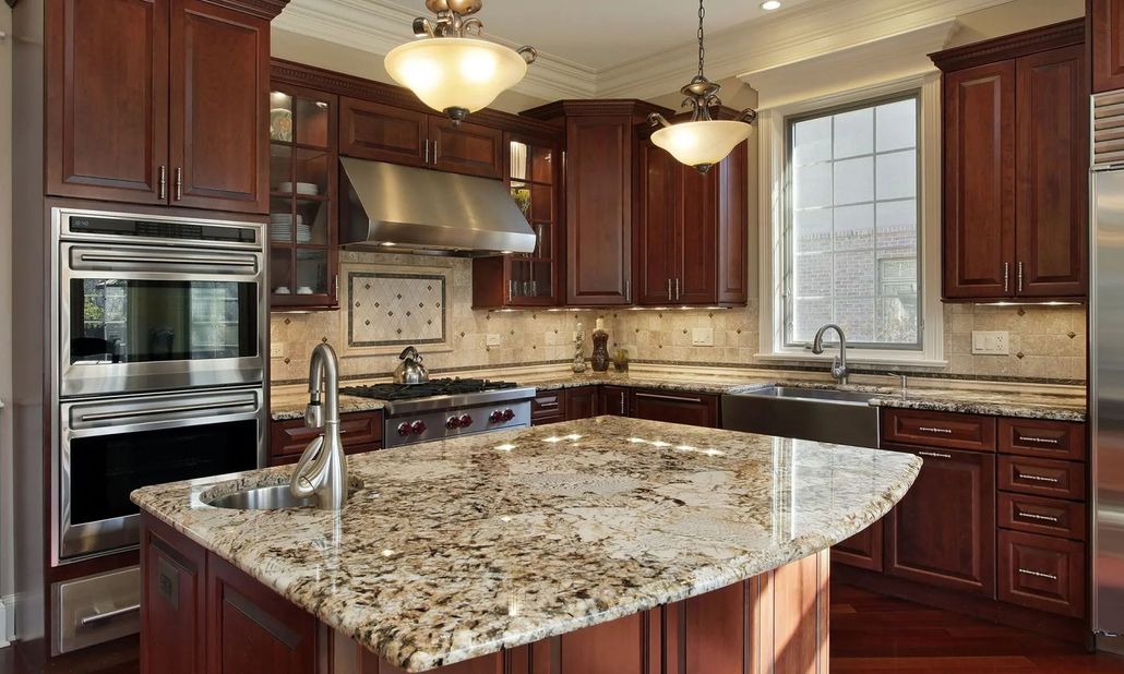 Luxury kitchen with dark wood cabinets, granite island, stainless appliances, and pendant lights