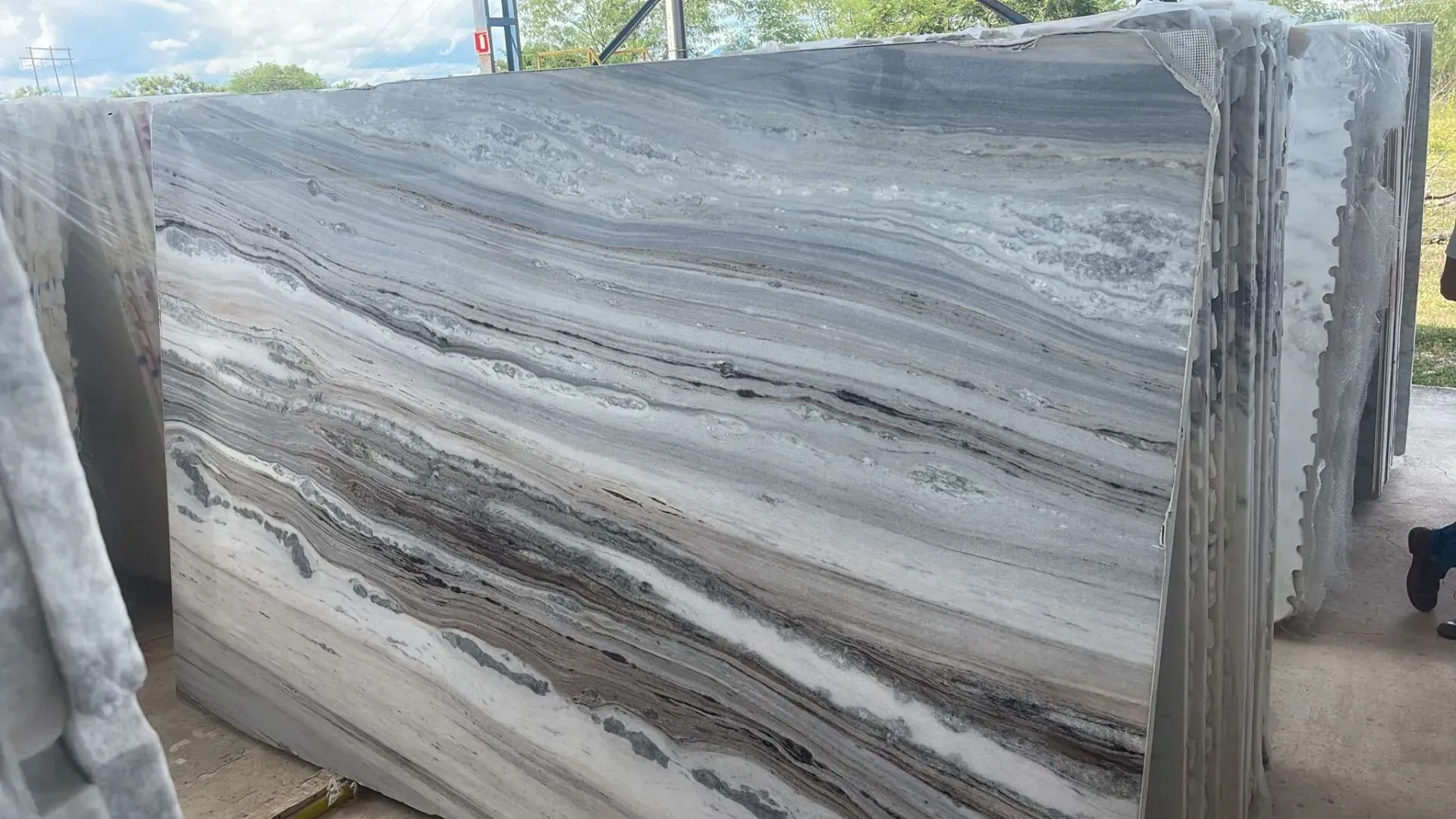 Large gray stone slabs stacked outdoors on a construction site