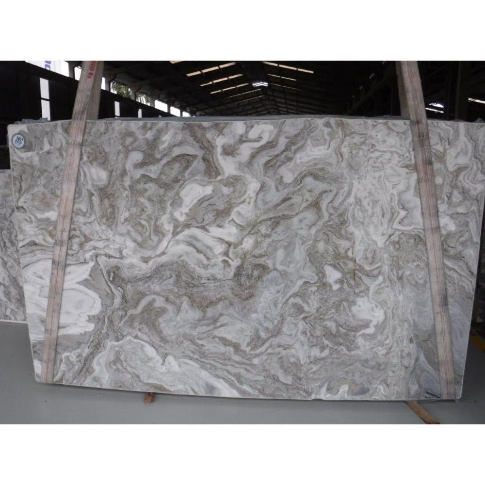 Large polished gray-and-white marble slab standing upright in a warehouse or stone yard