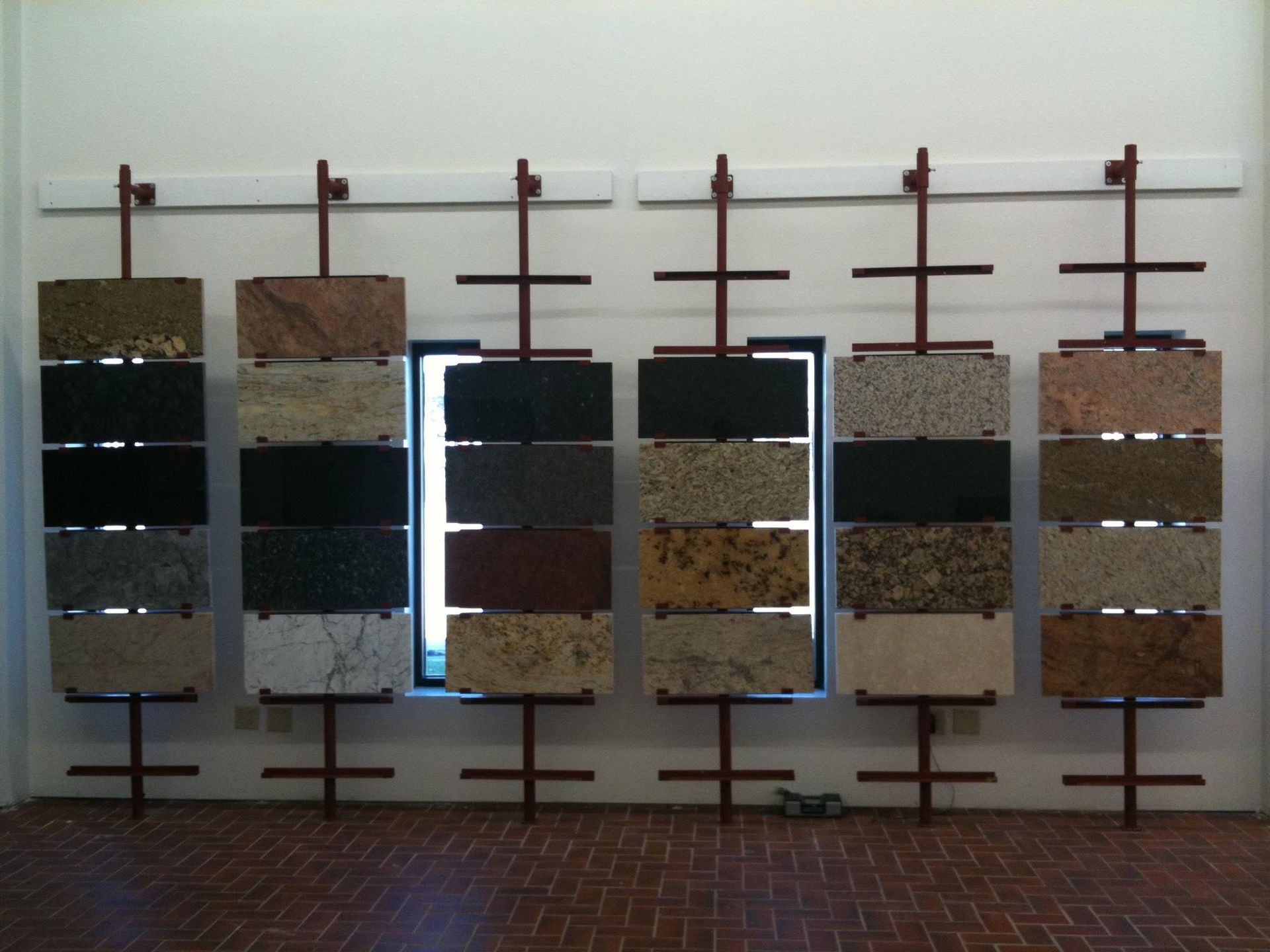Sample display of six vertical color and material swatch panels on a wall rack