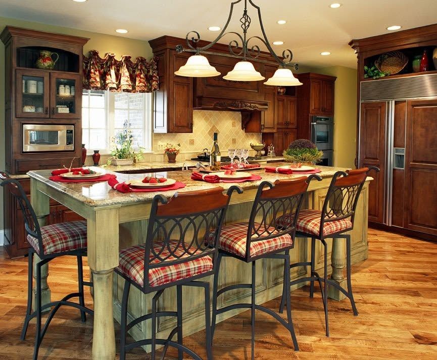Warm kitchen with a large island, pendant lights, and patterned bar stools on a hardwood floor