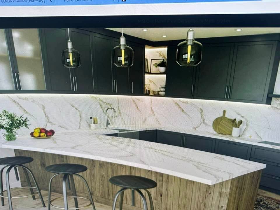 Modern kitchen with marble island, black cabinets, pendant lights, and three stools