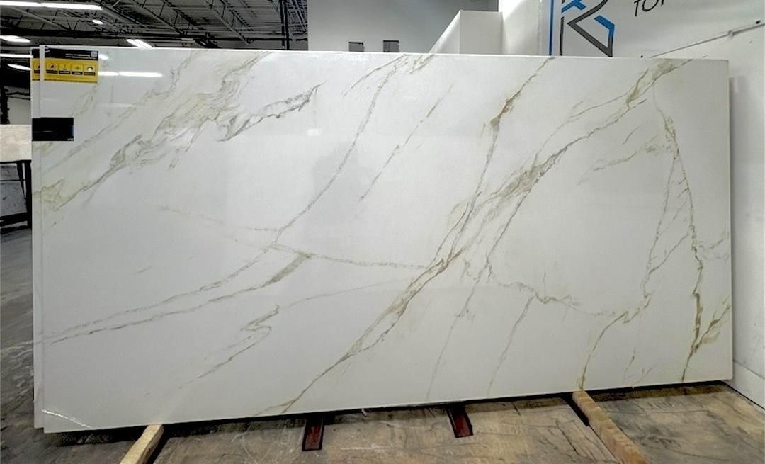 Large white marble slab with subtle gray veining leaning in a warehouse or stone yard