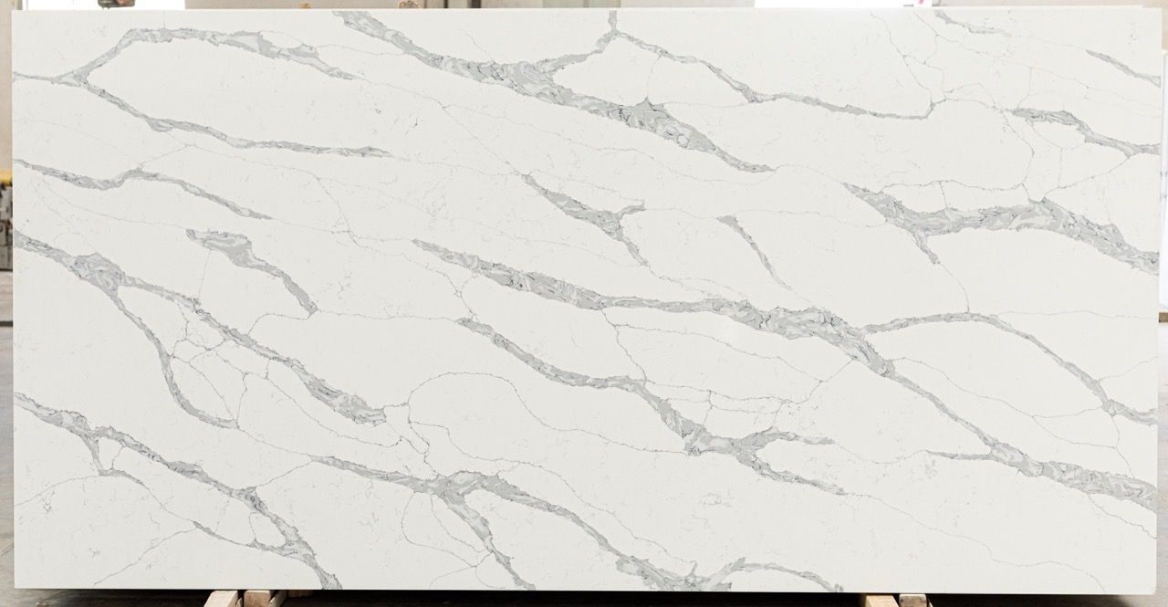 White marble slab with gray veining, viewed horizontally against a plain background