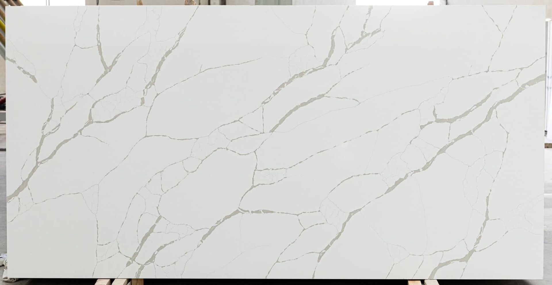 White marble-look slab with subtle gray veining and gold streaks