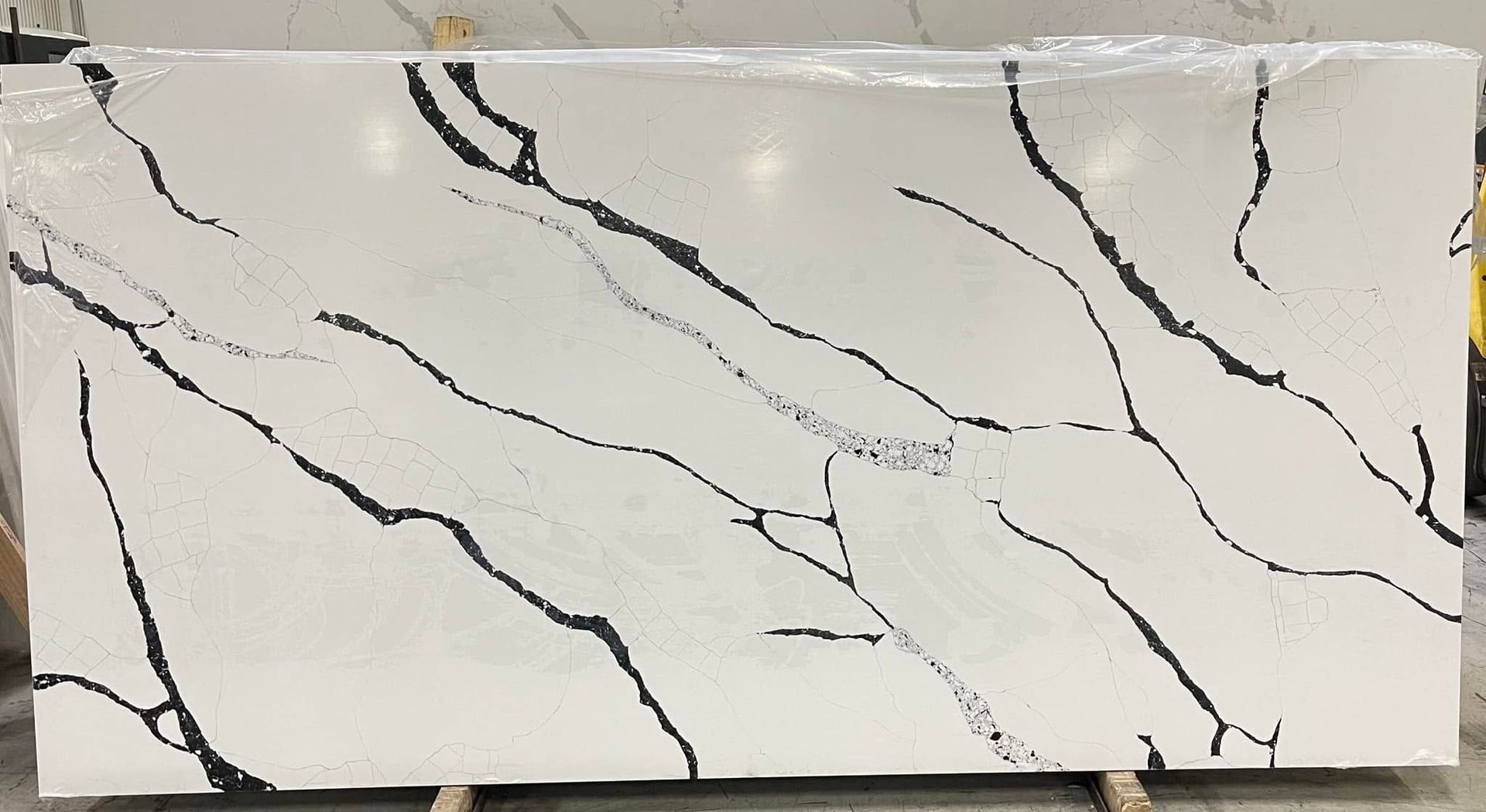 White rectangular tile with black veining, resembling marble.