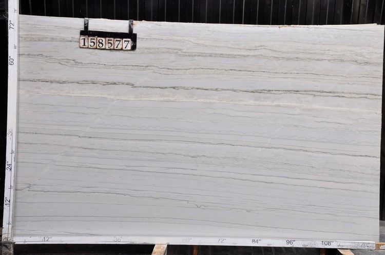 White corrugated wall or panel with a small black number sign near the top left.