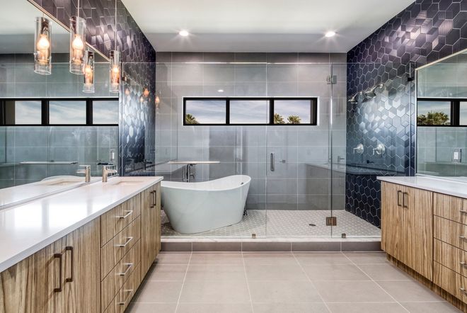 Modern luxury bathroom with double vanity, freestanding tub, glass shower, and wood cabinetry