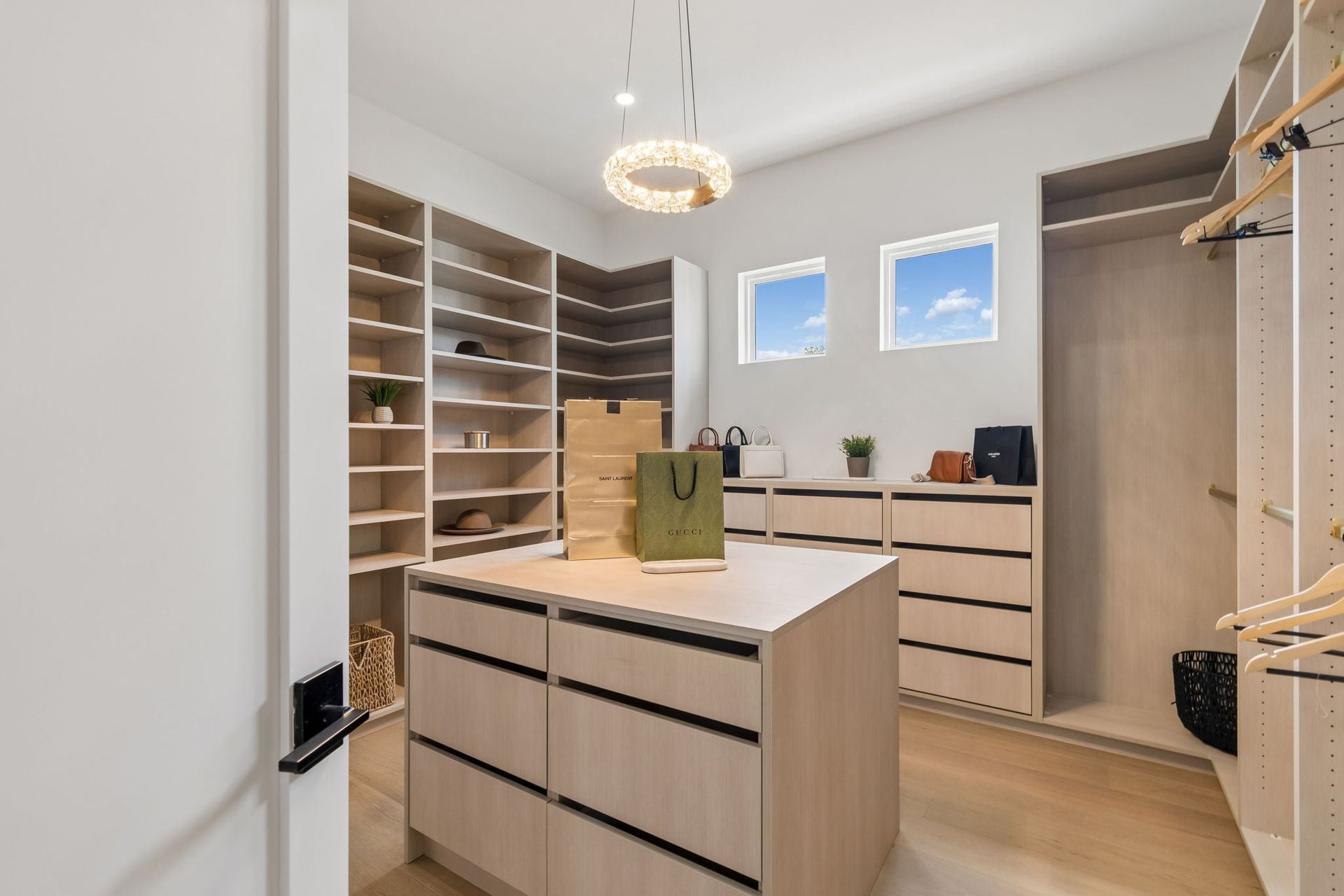 A modern kitchen with dark wood cabinets, a stainless steel range hood and oven, and a white kitchen island.