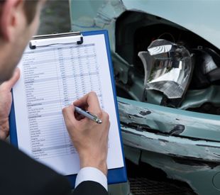 man Inspecting Car Accident