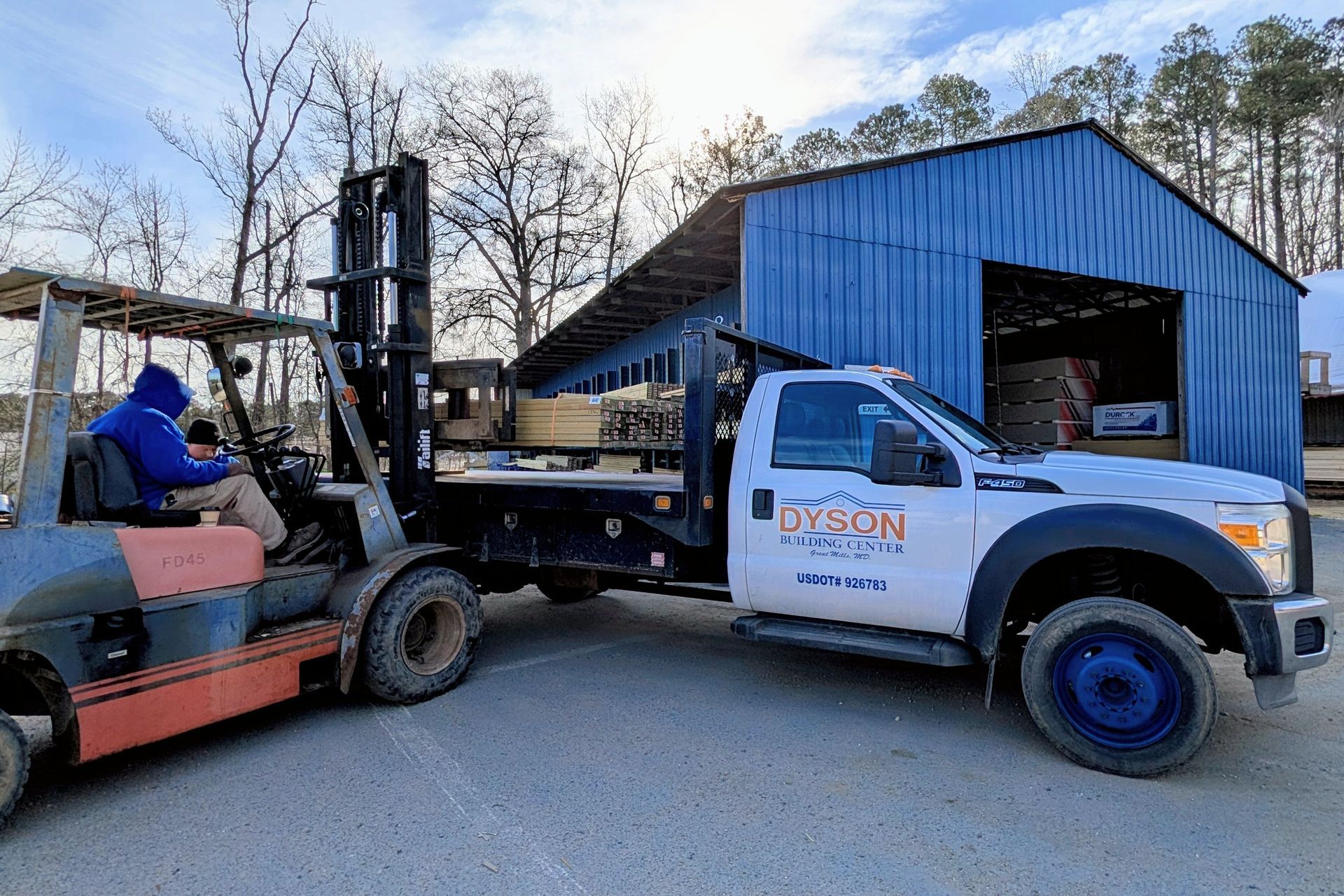 Lumber being loaded onto truck at home improvement cener at Dyson Building Center