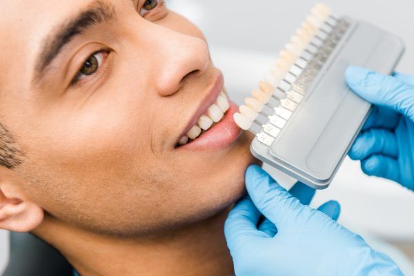 A man is getting his teeth examined by a dentist.