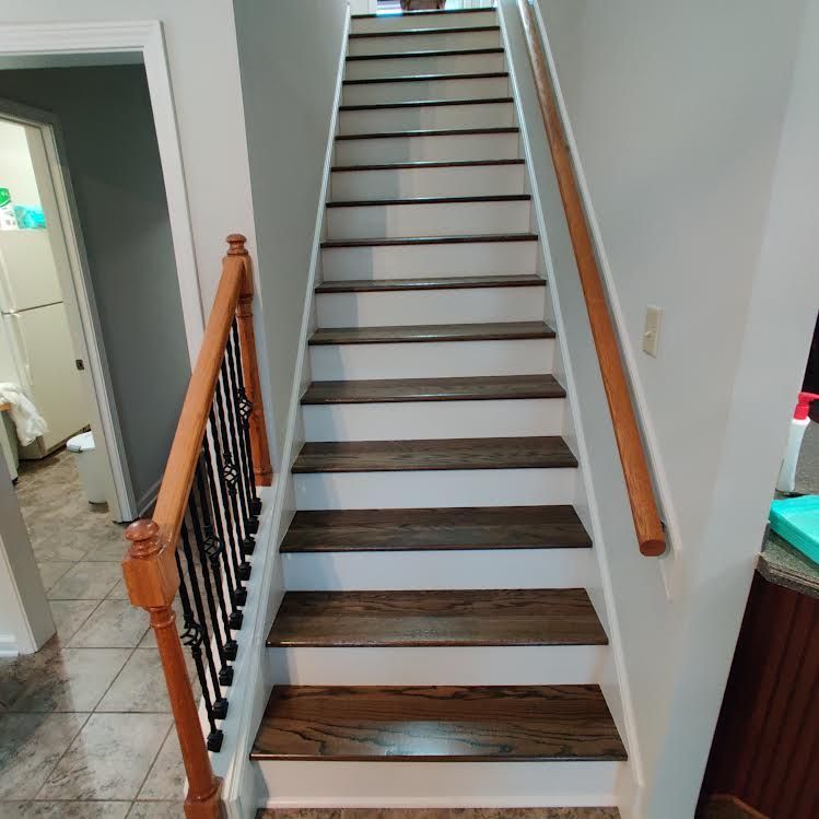 A staircase with wooden steps and a wooden railing in a house.