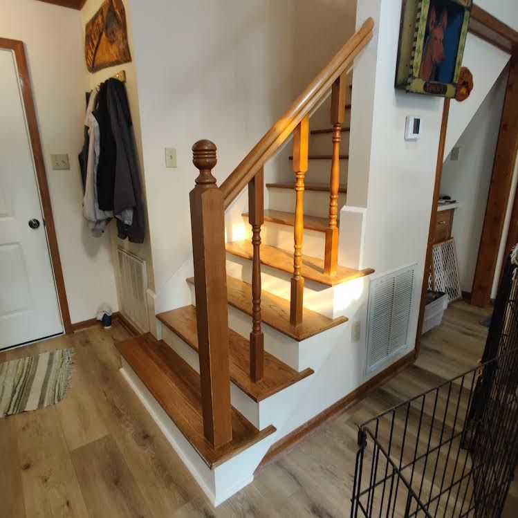 A staircase with a wooden railing in a hallway