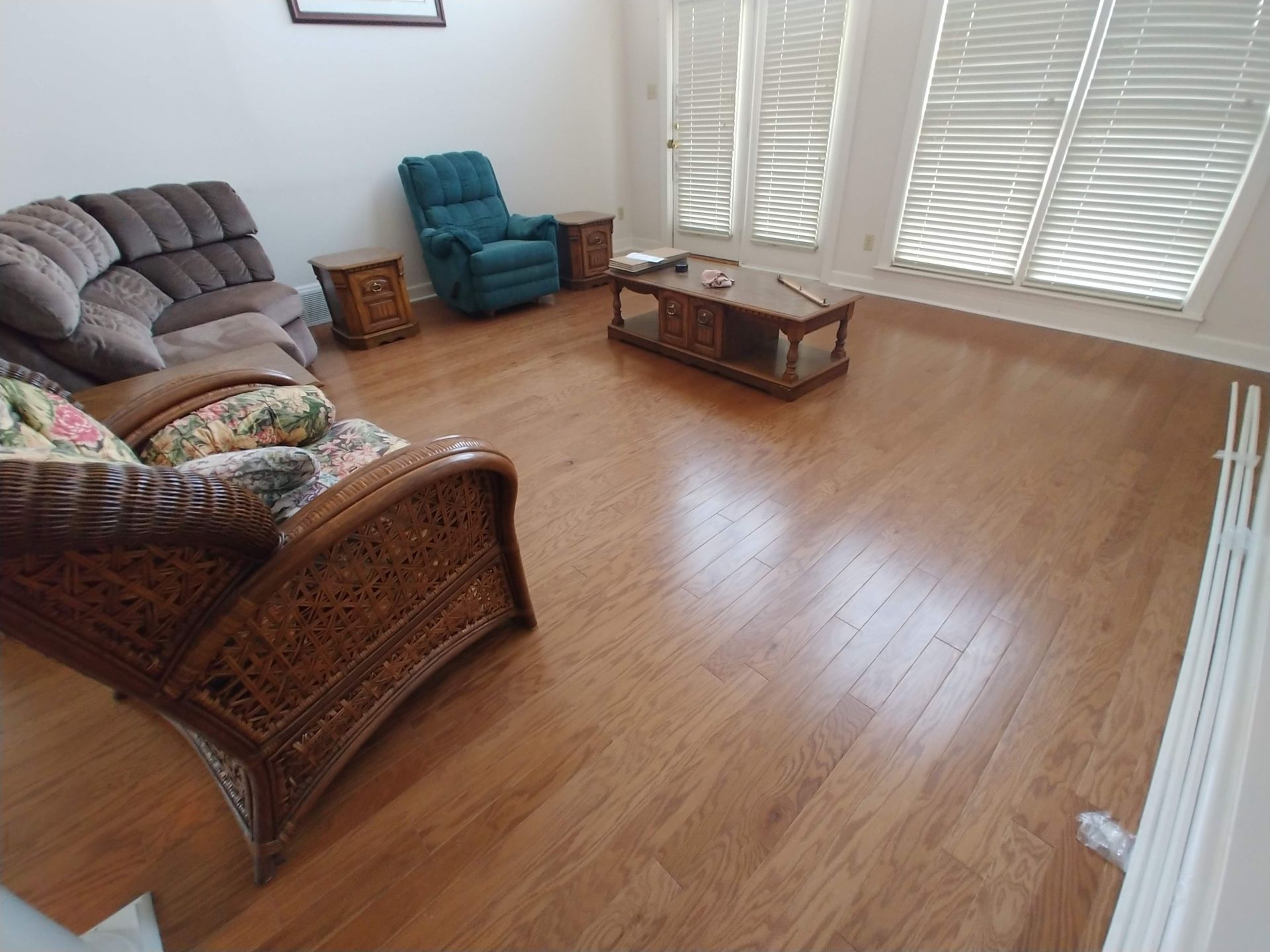 A living room with a couch , chair and coffee table