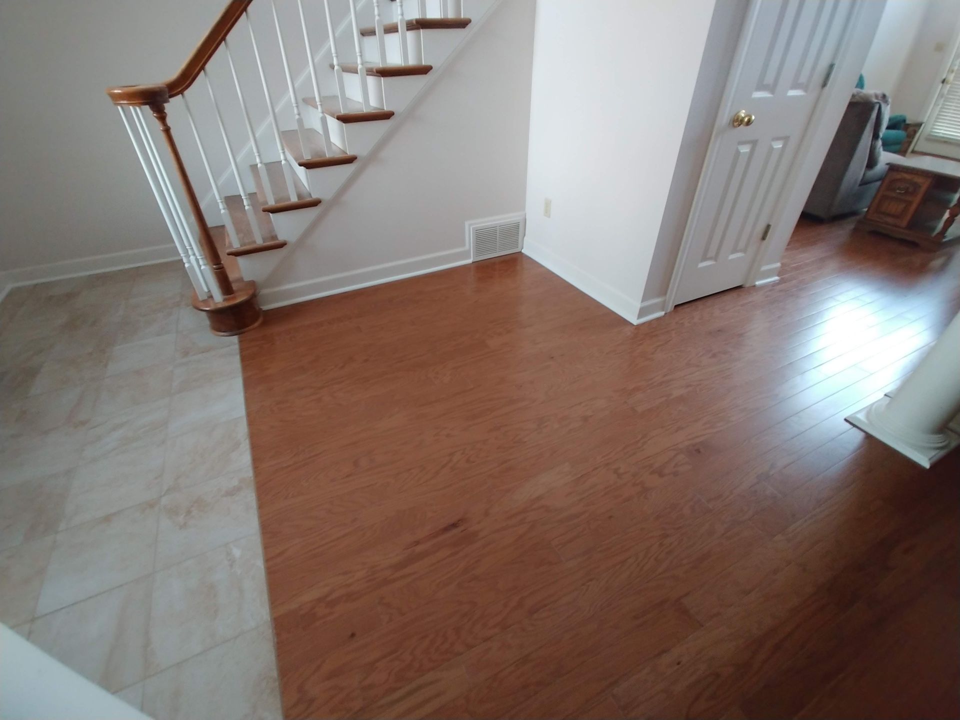 A staircase in a room with a wooden floor