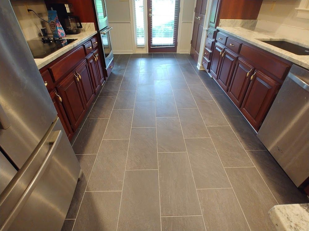 A kitchen with stainless steel appliances and wooden cabinets