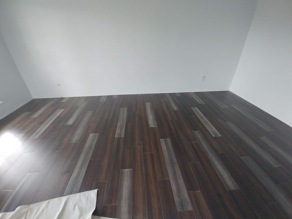 A room with a wooden floor and white walls