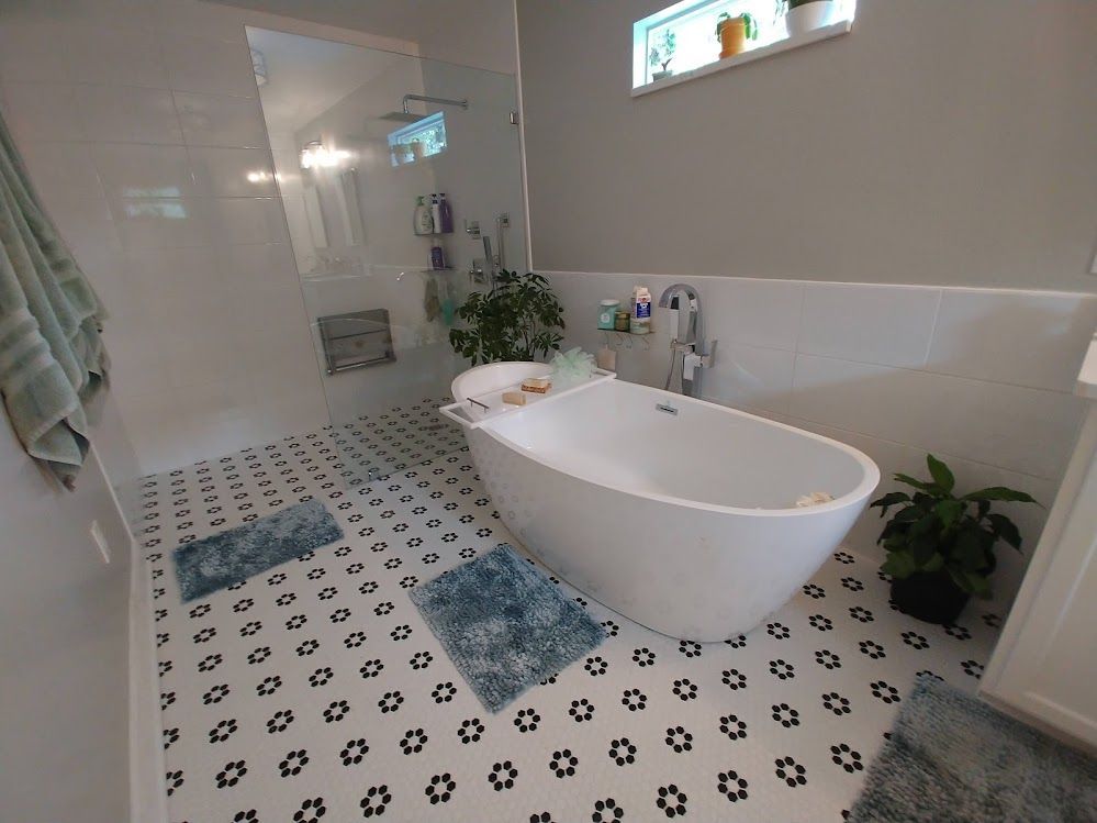 A bathroom with a bathtub and a shower.