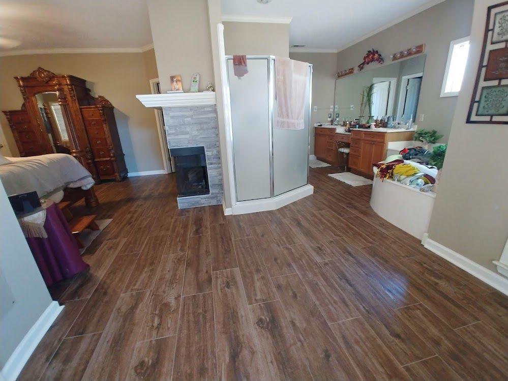 A living room with hardwood floors and a fireplace