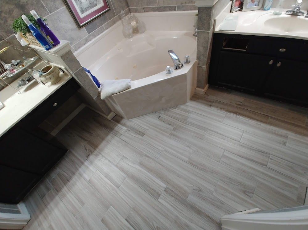 A bathroom with a jacuzzi tub and a sink