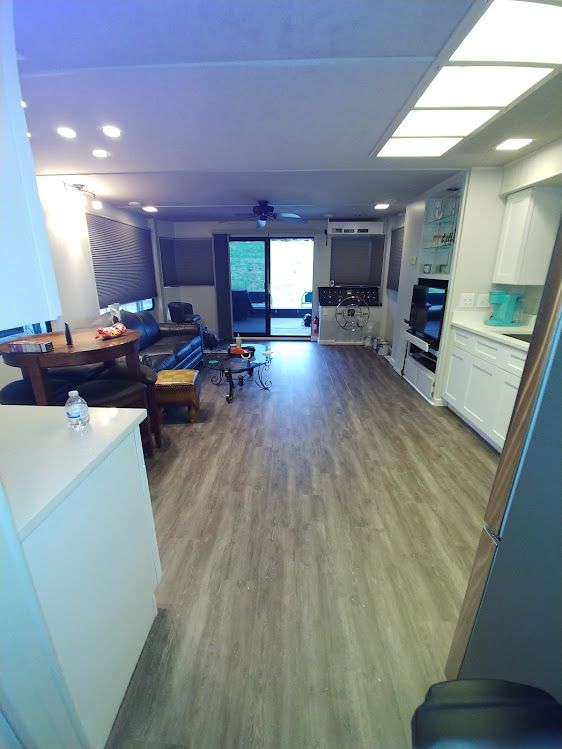 A living room with hardwood floors and a sliding glass door.