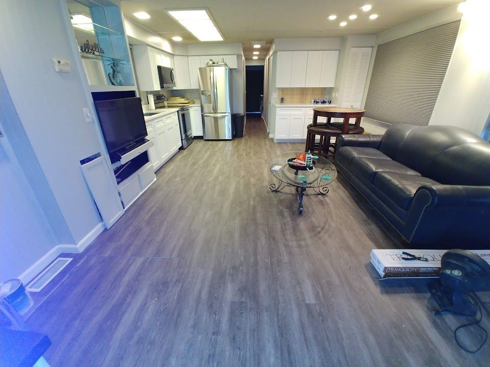 A living room with a couch , table , and television.