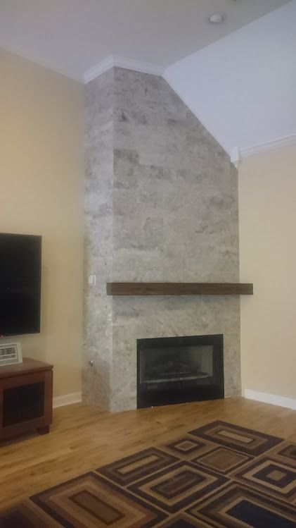 A living room with a fireplace and a flat screen tv.