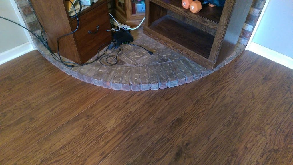 A living room with hardwood floors and a fireplace.