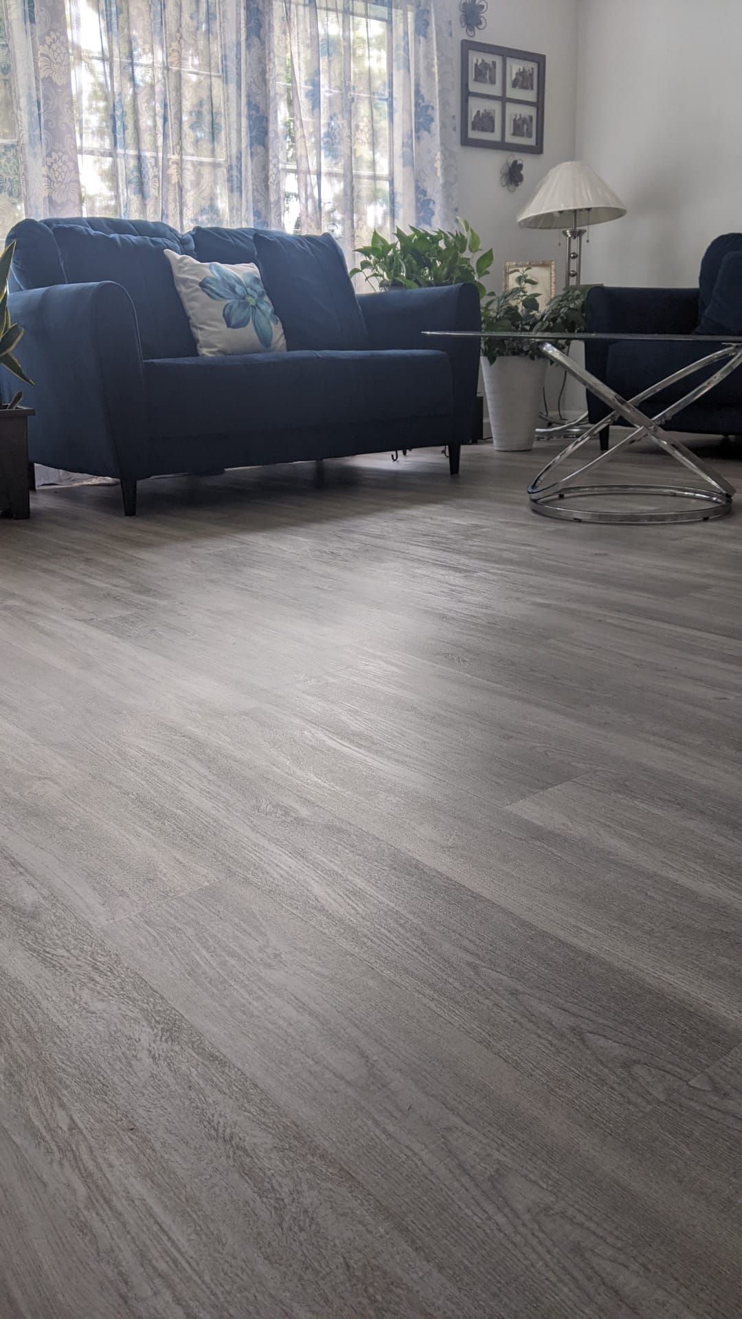 A living room with a couch , chairs , and a coffee table.