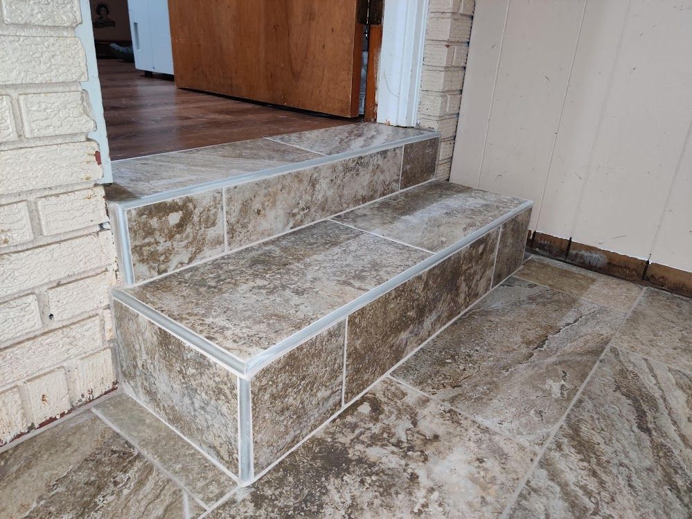 A set of tiled stairs leading up to a doorway.