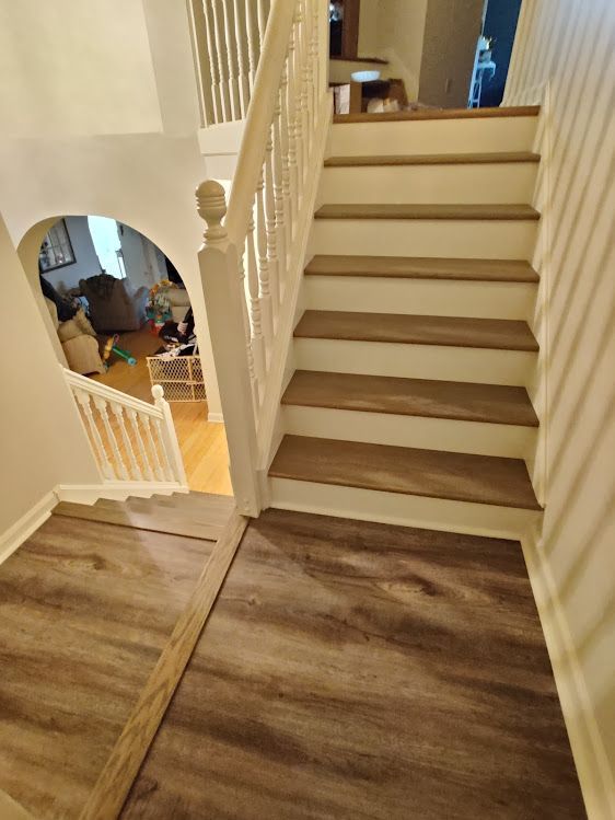 A staircase with wooden steps and a white railing in a house.