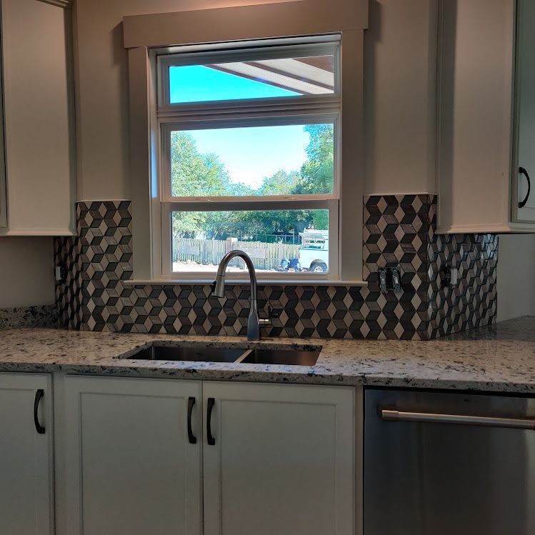 A kitchen with a sink and a window over it