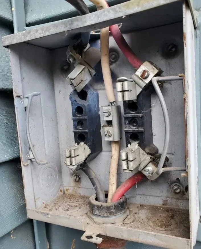 Storm damage in meter socket. This occurred when a tree fell on the mast and the wires were pulled out and stretched.
