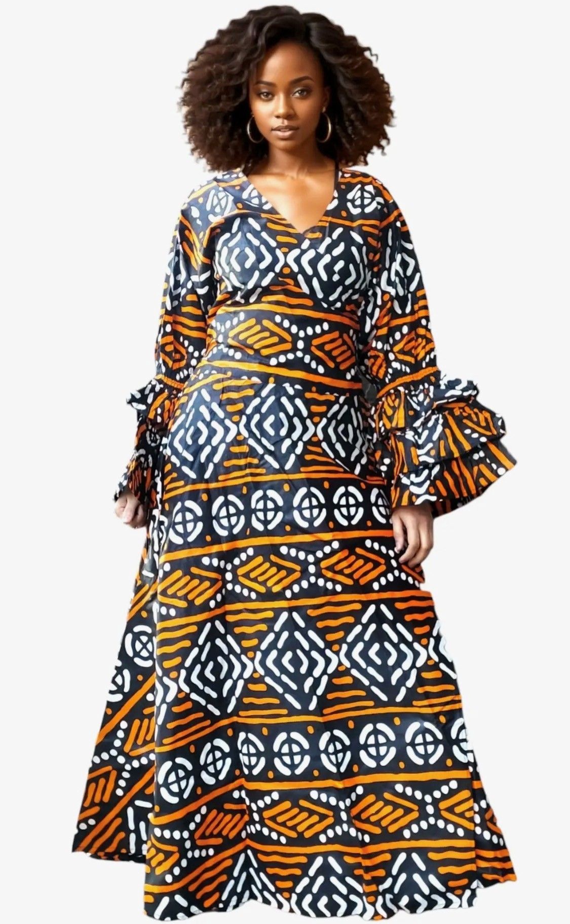 Woman wearing a long, patterned dress with bell sleeves and a deep neckline, standing.