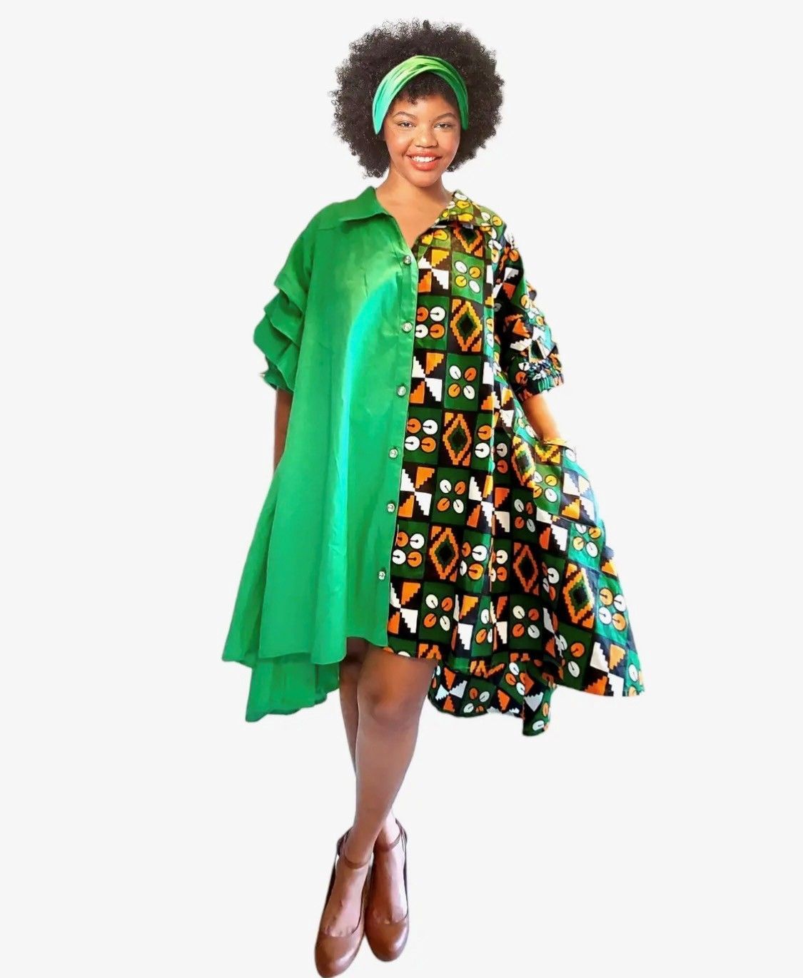 Woman in a green and patterned half-and-half dress, wearing a headband, and brown shoes.