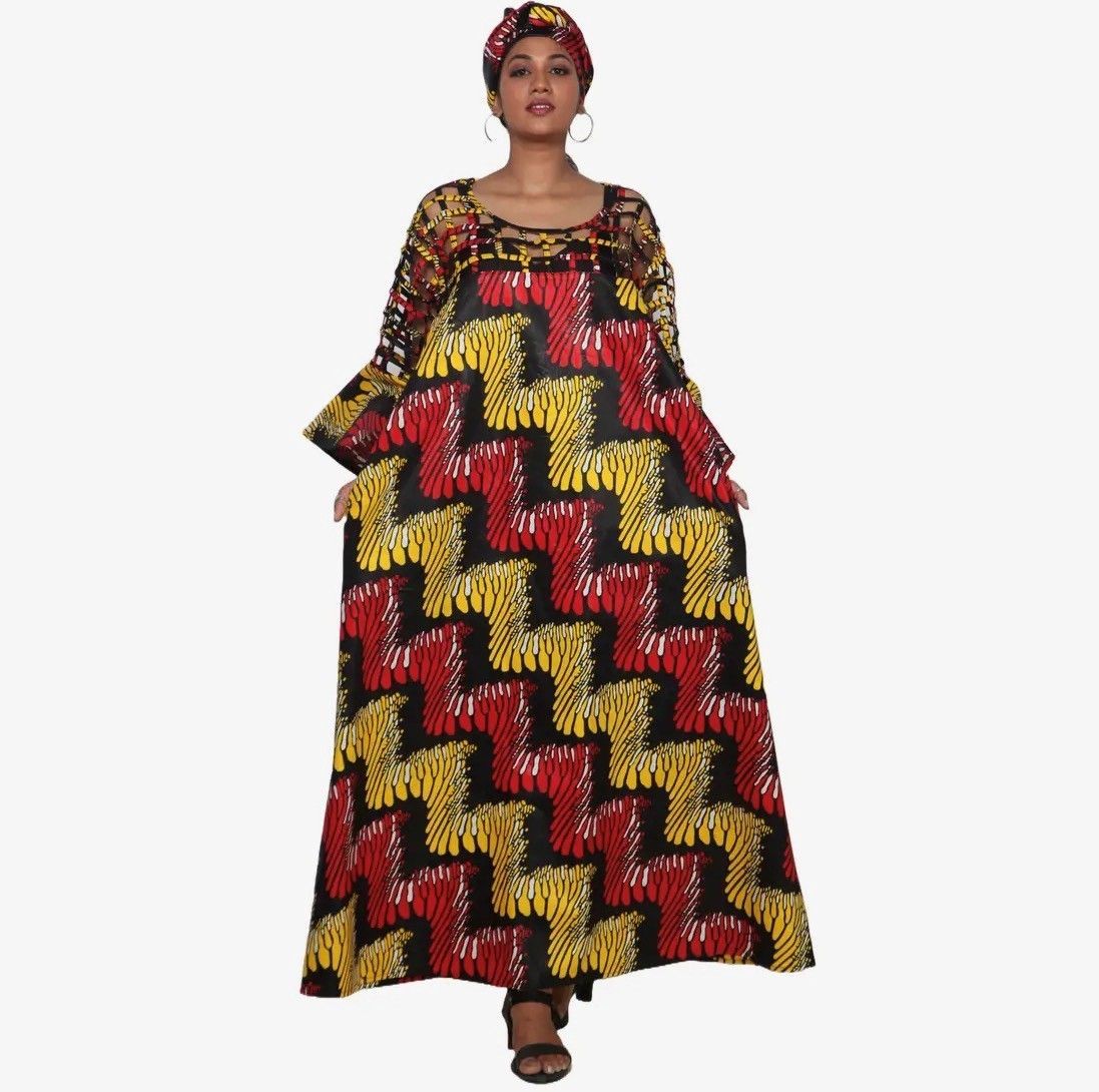Woman in colorful patterned African dress and head wrap.