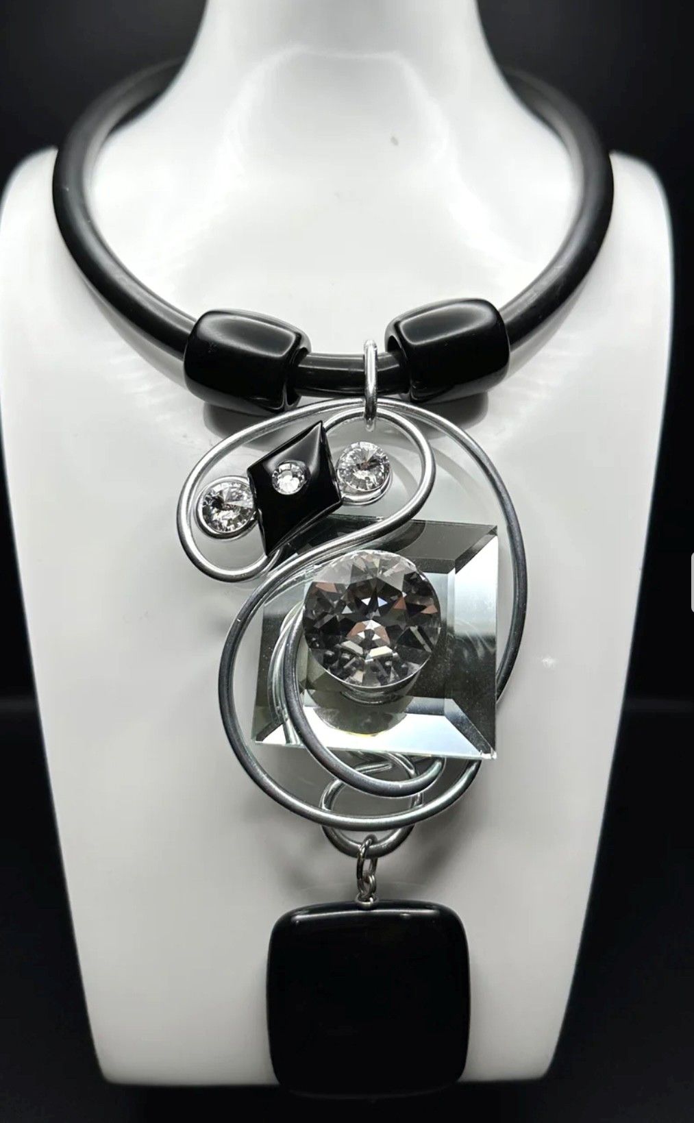 A necklace with a pendant on a mannequin