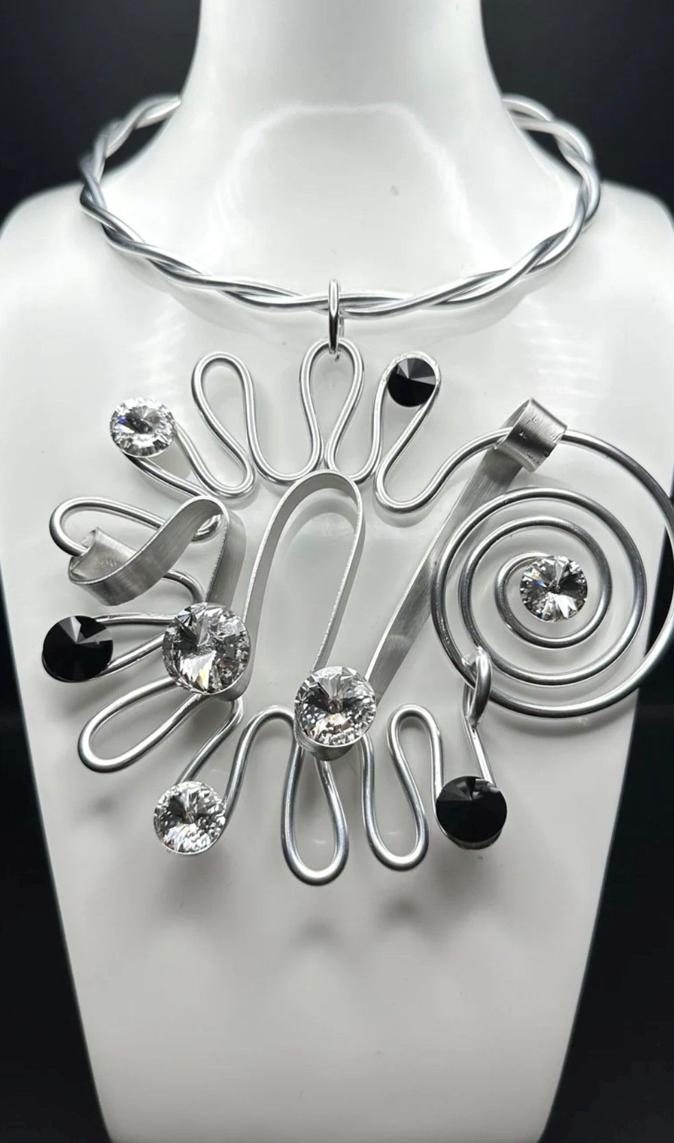 A close up of a necklace on a mannequin