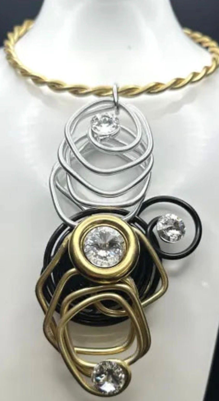 A close up of a necklace on a mannequin